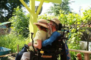 Debra and David on their back accessible deck, looking over their ecogarden.